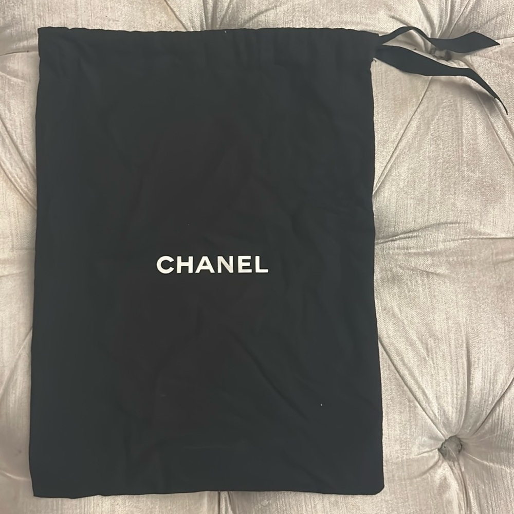 Black Chanel, soft, leathery, cotton silk feel with ribbon ties. 
Made in Italy